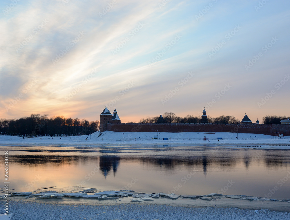 Dvortsovaya and Spasskaya towers of the Novgorod Kremlin against the sunset sky. Urban winter landscape