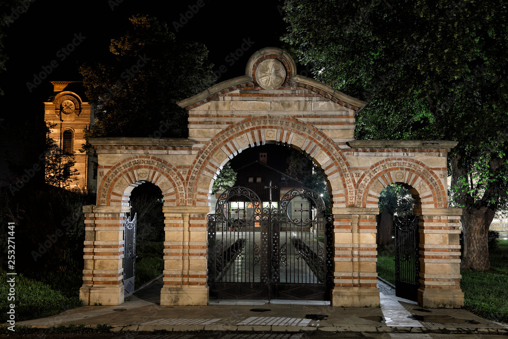 Fototapeta premium Medieval Ornamental Stone And Metal Gate With Metal Orthodox Crosses At Night 