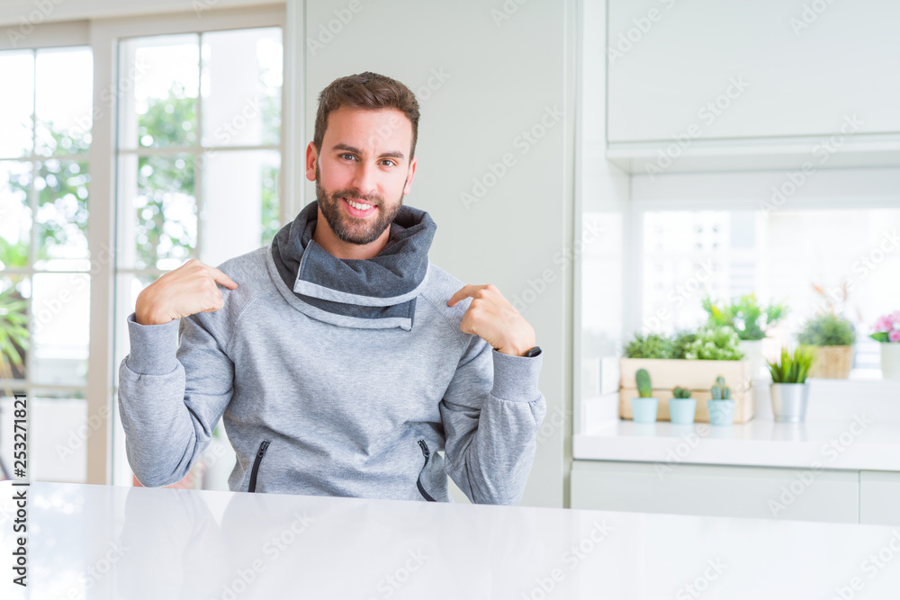 Handsome man at home looking confident with smile on face, pointing oneself with fingers proud and happy. Handsome man at home looking confident with smile on face, pointing oneself with fingers proud and happy.