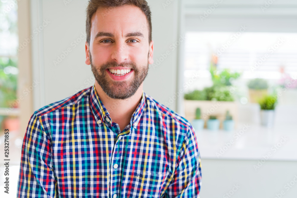 Handsome man wearing colorful shirt and smiling positive at the camera Handsome man wearing colorful shirt and smiling positive at the camera
