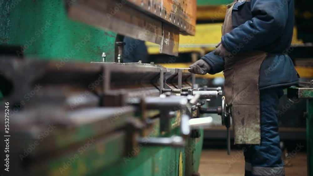 Industrial concept. A big industrial machine deflecting a metal detail with a press Industrial concept. A big industrial machine deflecting a metal detail with a press