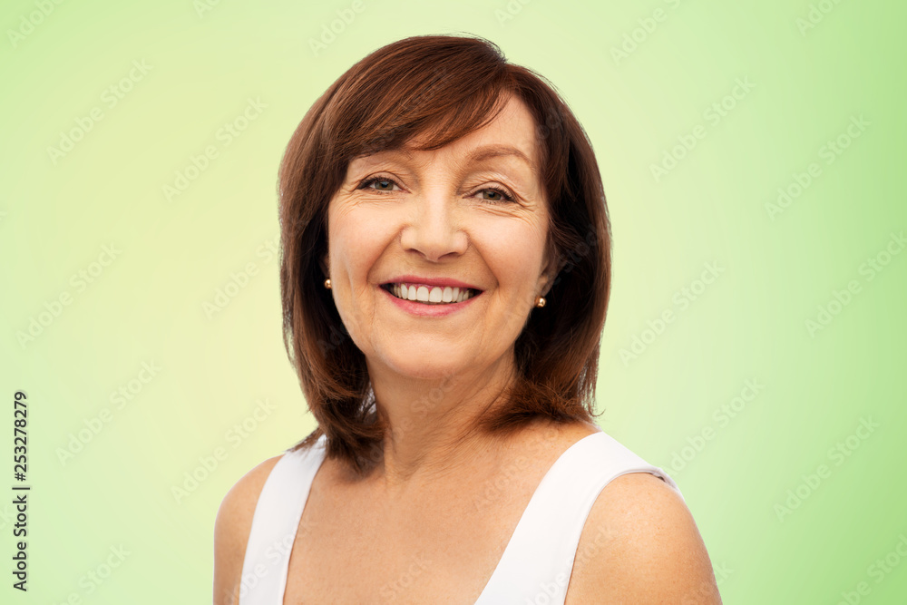 beauty and old people concept - portrait of smiling senior woman over lime green natural background beauty and old people concept - portrait of smiling senior woman over lime green natural background