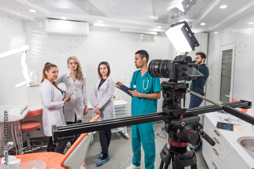 Group of filmmakers shooting a movie in a dentistry