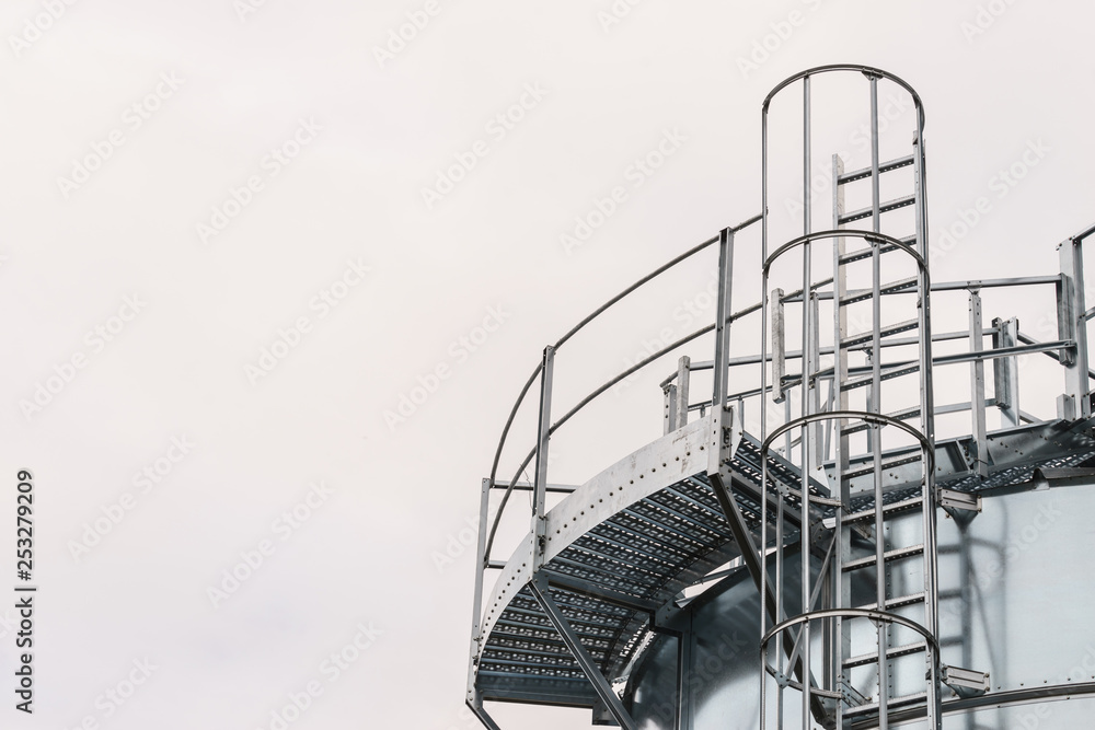 Industrial metal ladder with round railing Stock Photo | Adobe Stock