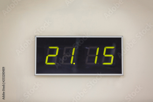 Black digital clock on a white background showing time 21.15 minutes