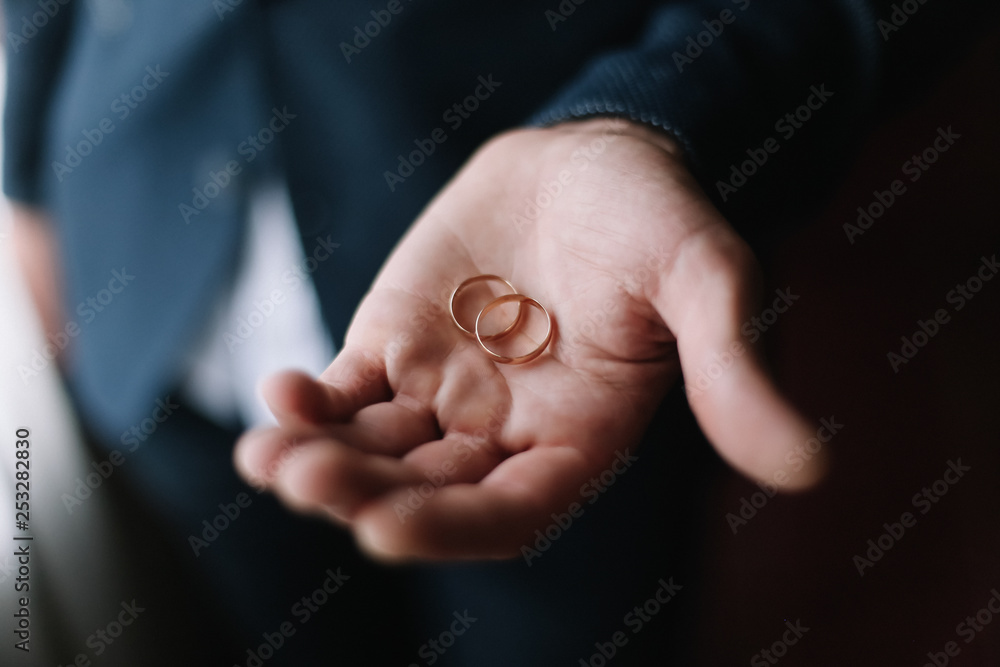Hands of groom with rings