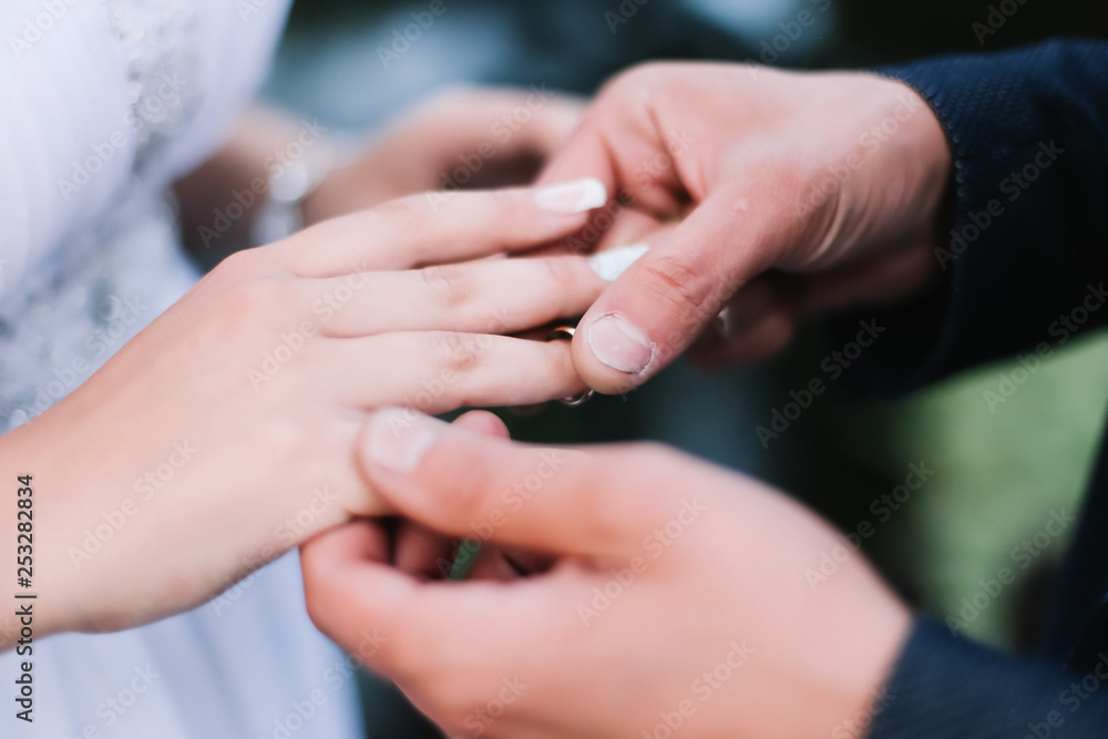 Hands of groom and bride with rings. wedding dress, wedding details 