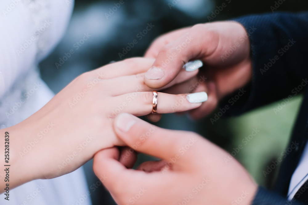 Hands of groom and bride with rings