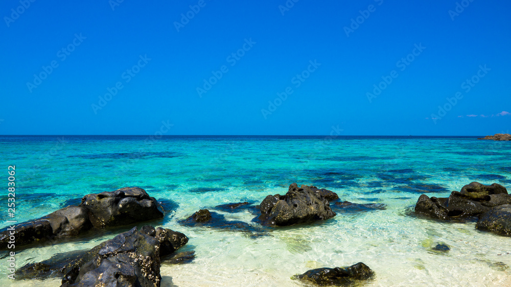 stone beach, blue sky and sea 