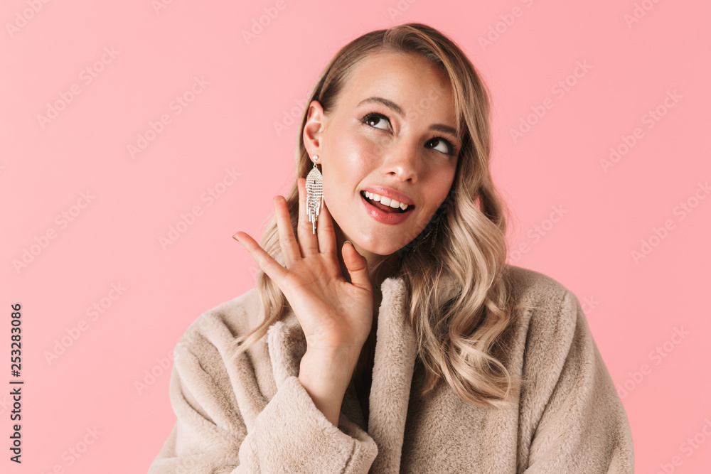 Pretty woman posing isolated over pink wall background wearing accessories and jewelry. Pretty woman posing isolated over pink wall background wearing accessories and jewelry.