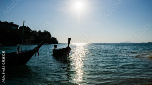 boat on the beach, sun and trees