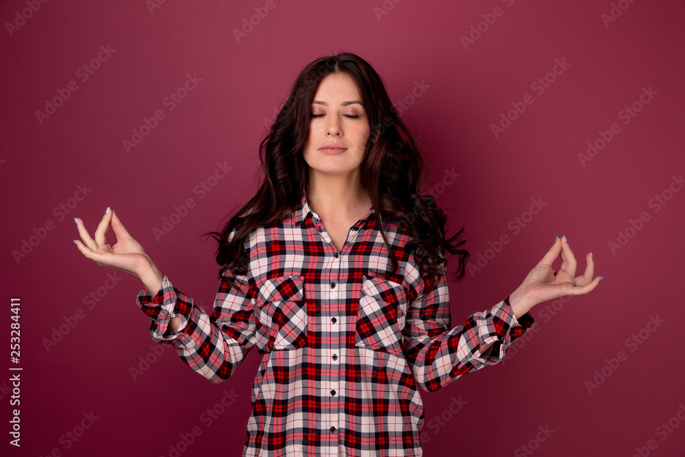 Pretty woman in a keep calm pose isolated over the dark pink background
