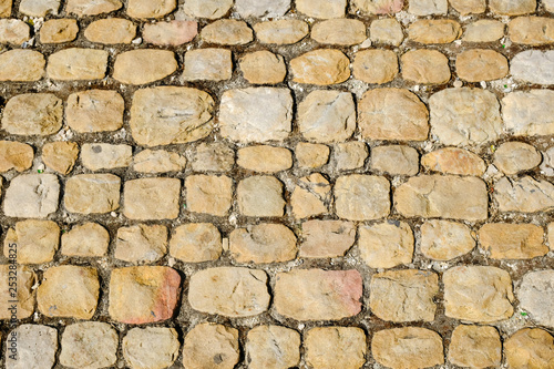 Road surface paved with cobblestone, Italy. Texture for design and backgrounds.