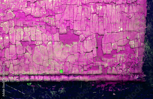 Old wooden background with remains of pieces of scraps of old paint on wood. Texture of an old tree  board with paint  vintage background peeling paint.