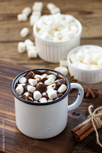 Hot chocolate with marshmallows in a white metal vintage mug