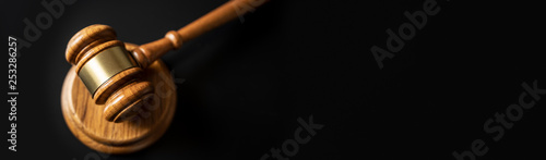 judge or auction Gavel on a wood block in courtroom, dark background photo