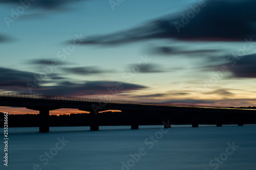 Fototapeta Naklejka Na Ścianę i Meble -  Nice sunset after a viaduct crossing over a lake
