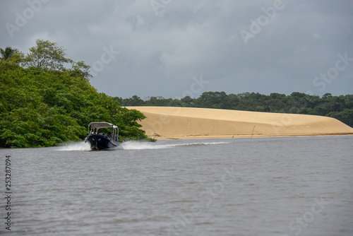 Tourist boat travelling from Atins to Barreirinhas on river Preguicas in Brazil photo