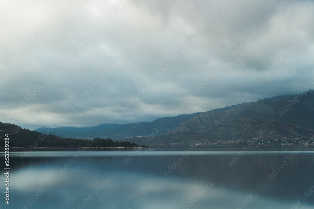 Beautiful reflections of clouds and mountains in the water of a lake