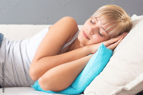 Beautiful young woman sleeping on sofa