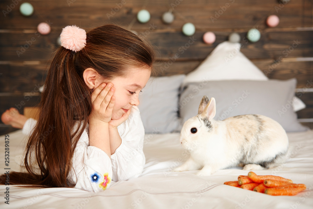 Cheerful girl looking at rabbit Cheerful girl looking at rabbit