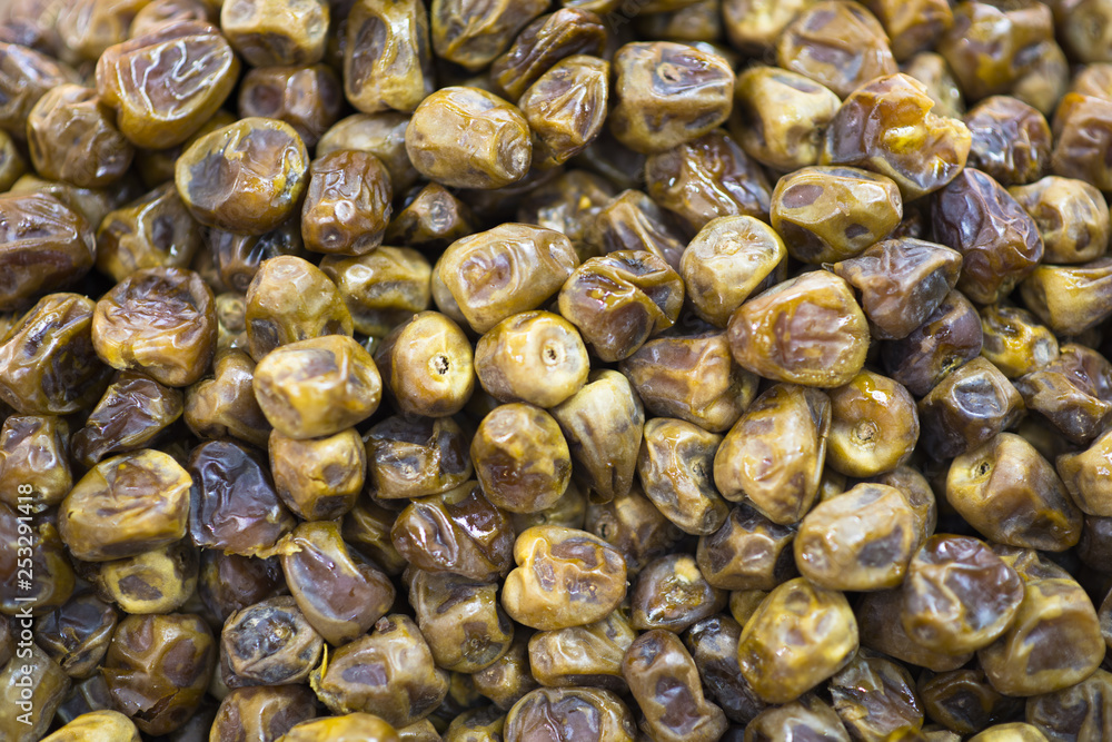 Dried dates fruits as background, sweet and tasty desert from orient Dried dates fruits as background, sweet and tasty desert from orient