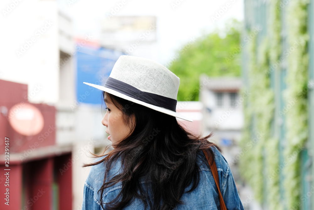 Back side of woman traveler standing with city outdoors background, casual lifesyle, travel blogger Back side of woman traveler standing with city outdoors background, casual lifesyle, travel blogger