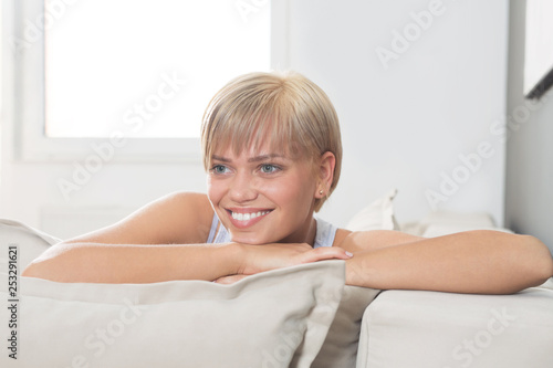 Young woman smiling on sofa
