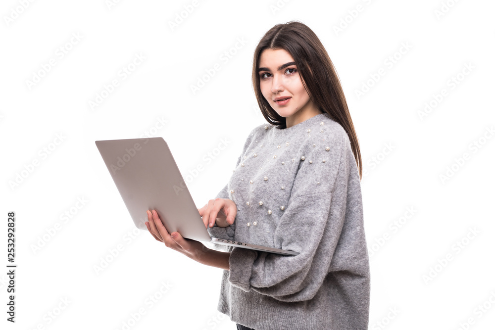 Naklejka premium Portrait of a happy woman using laptop computer isolated on a white background