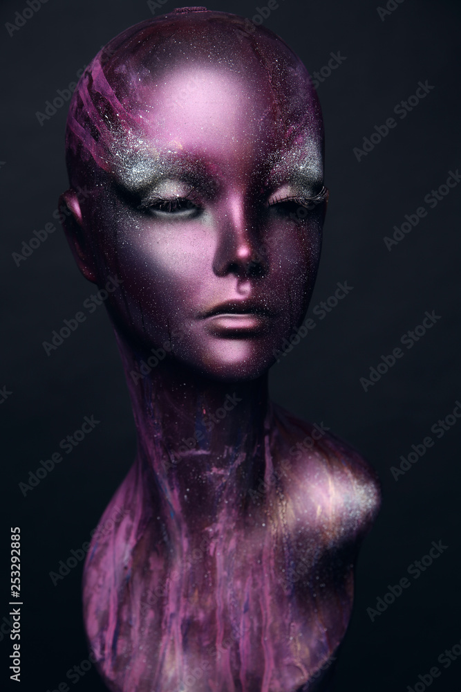 Closeup studio shot of violet woman mannequin with stylish makeup, dark background Closeup studio shot of violet woman mannequin with stylish makeup, dark background