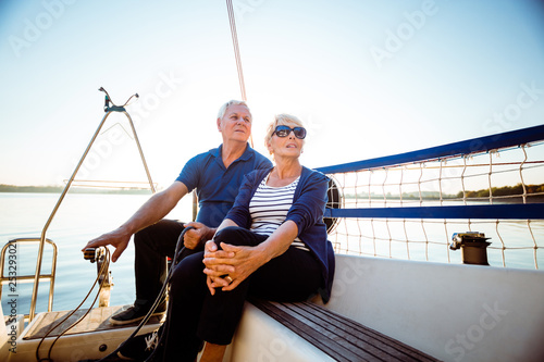 Couple traveling in sailboat during summer vacation © Snapic.PhotoProduct