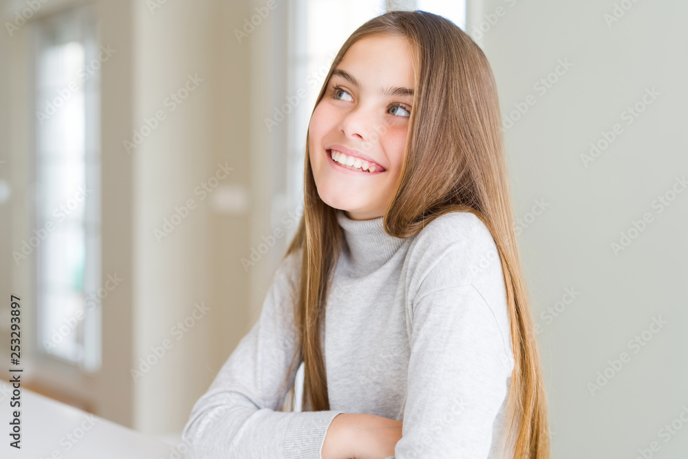Beautiful young girl kid wearing turtleneck sweater smiling looking side and staring away thinking. Beautiful young girl kid wearing turtleneck sweater smiling looking side and staring away thinking.