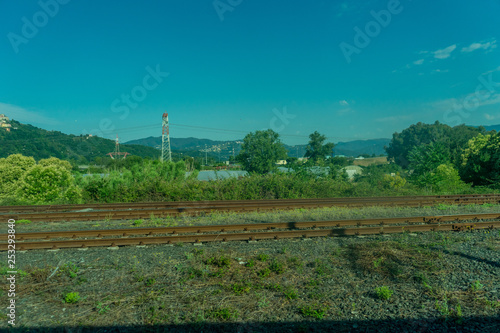 Fototapeta Naklejka Na Ścianę i Meble -  Italy,La Spezia to Kasltelruth train, a large green field with trees in the background