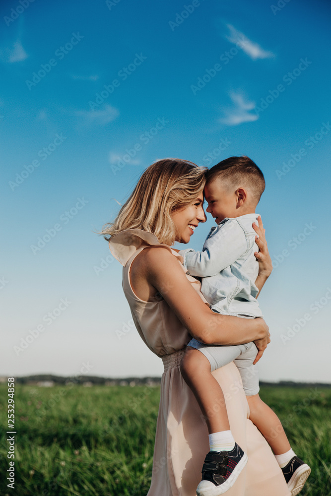 Fototapeta premium Young mother and her adorable little son outdoor
