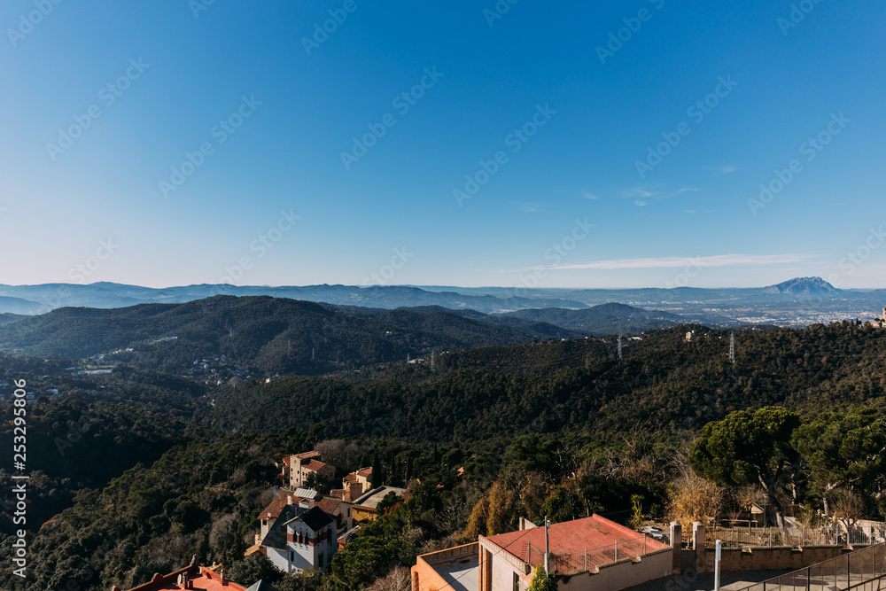 scenic view of houses, green hills and mountains, barcelona, spain