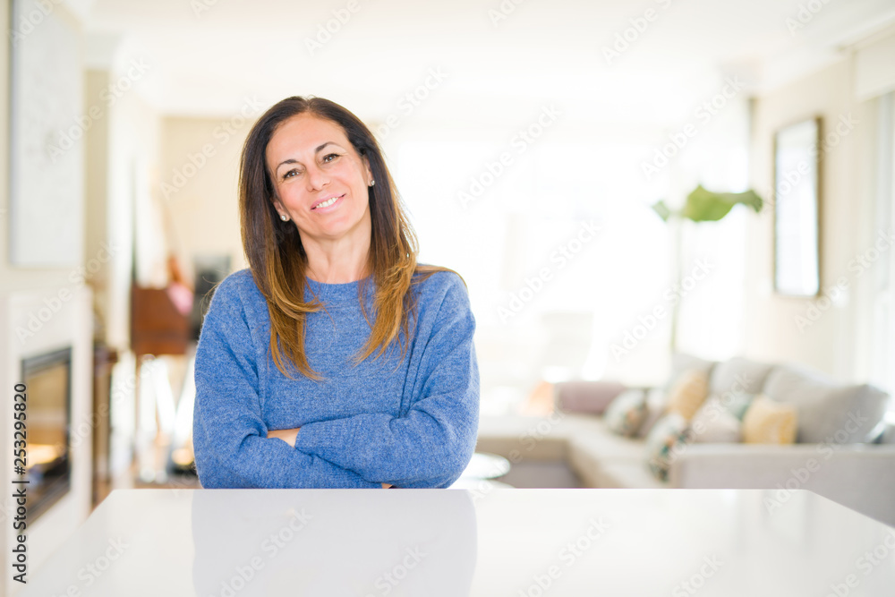 Beautiful middle age woman at home happy face smiling with crossed arms looking at the camera. Positive person. Beautiful middle age woman at home happy face smiling with crossed arms looking at the camera. Positive person.