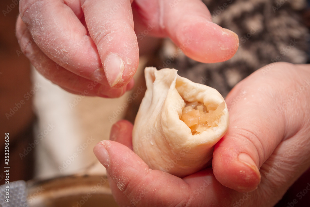 Cooking pies with cabbage in the home of an elderly woman Cooking pies with cabbage in the home of an elderly woman