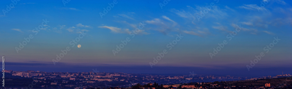 Evening small city town panorama. Blue sky - full moon.