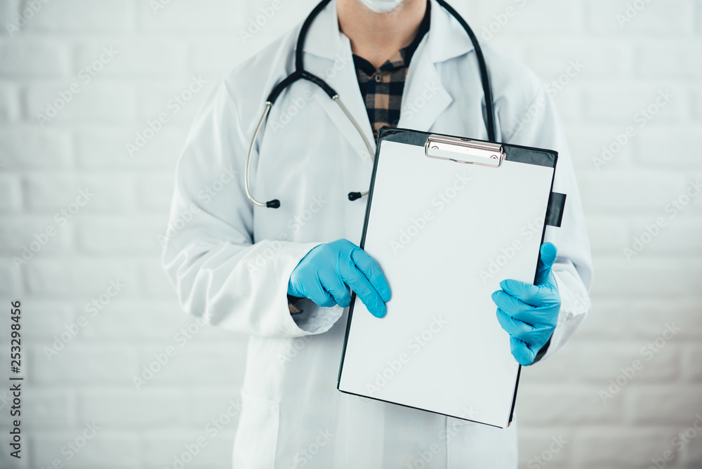 male doctor showing a blank clipboard isolated on white background male doctor showing a blank clipboard isolated on white background
