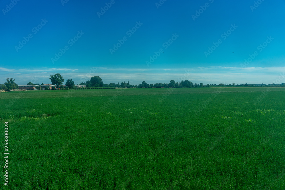 Italy,La Spezia to Kasltelruth train, a large green field with trees in the background Italy,La Spezia to Kasltelruth train, a large green field with trees in the background