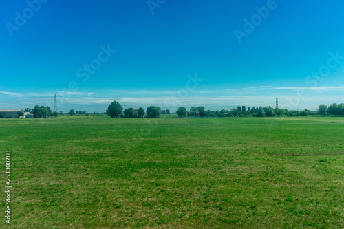 Italy,La Spezia to Kasltelruth train, a large green field with trees in the background © SkandaRamana