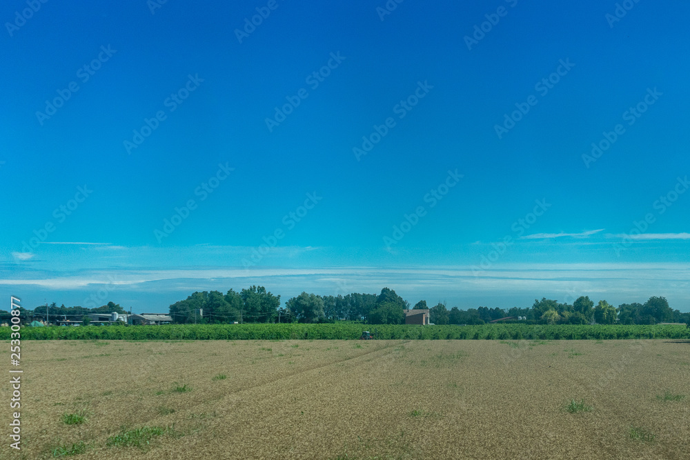 Fototapeta premium Italy,La Spezia to Kasltelruth train, a large green field with trees in the background