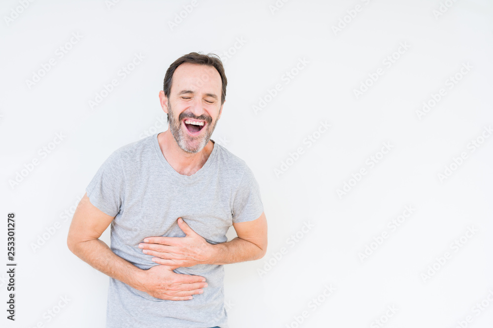 Handsome senior man over isolated background Smiling and laughing hard out loud because funny crazy joke. Happy expression. Handsome senior man over isolated background Smiling and laughing hard out loud because funny crazy joke. Happy expression.