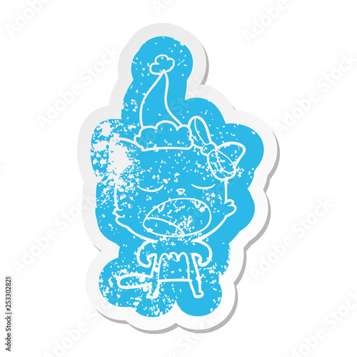cartoon distressed sticker of a cat meowing wearing santa hat