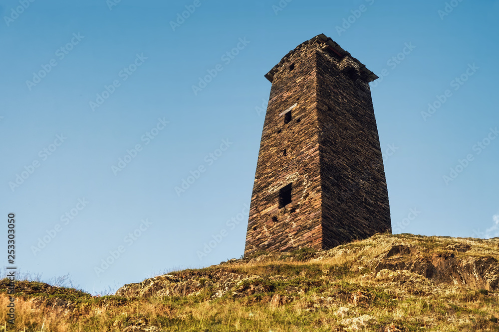 Single svan tower standing on a hill, view from bottom