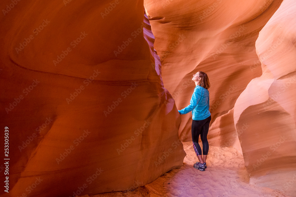 Young woman in Antelope Canyon in Arizona. Tourist in Antelope Canyon. Adventure and hiking concept. - obrazy, fototapety, plakaty 