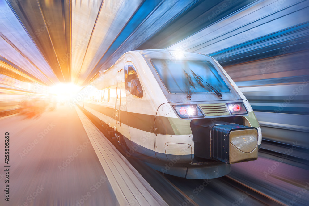 Railroad travel passenger train with motion blur effect, industrial a district of the city Railroad travel passenger train with motion blur effect, industrial a district of the city