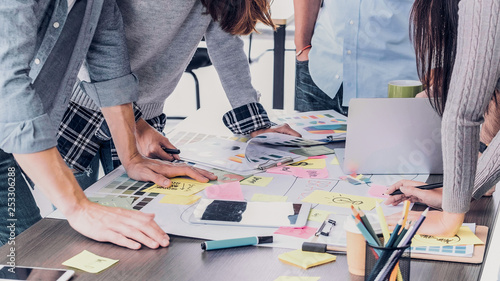 Close up creative designer applaud for job success at meeting table at office. photo