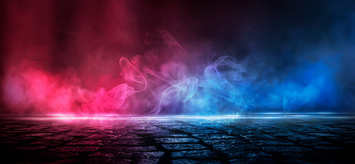 Wet asphalt, reflection of neon lights, a searchlight, smoke. Abstract light in a dark empty street with smoke, smog. Dark background scene of empty street, night view, night city.