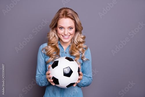 Portrait of her she nice cute lovely charming attractive cheerful cheery wavy-haired lady wearing blue shirt holding in hands black and white ball isolated over gray  background © deagreez